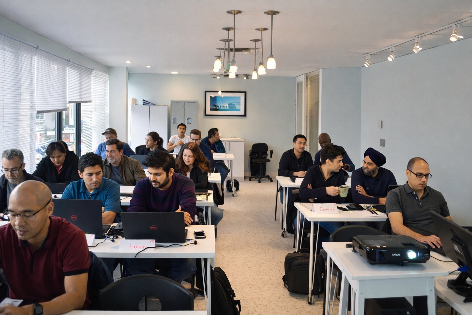 Students working at laptops during a class at InnoTech College